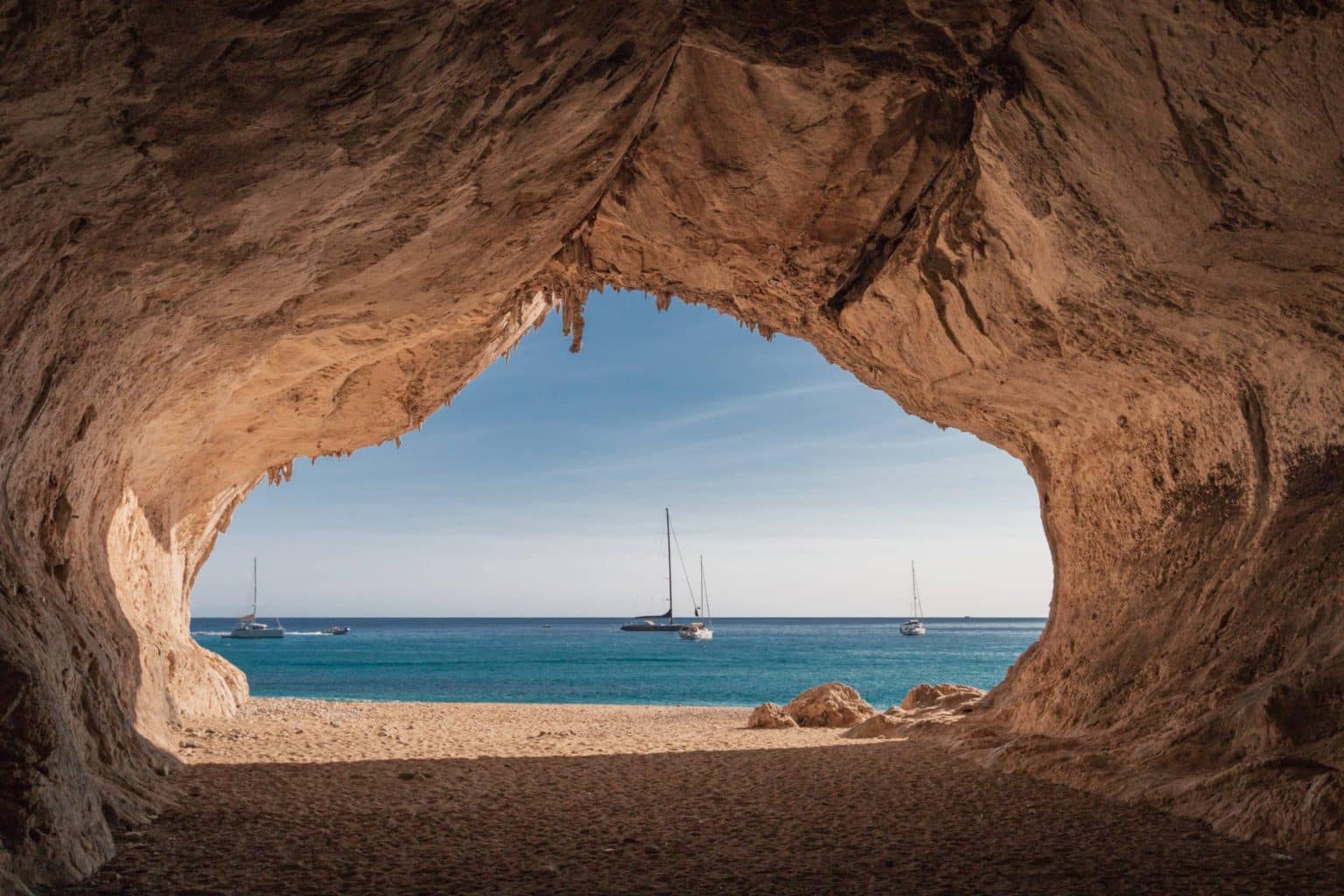 jpeg-optimizer_shutterstock_1108161788 nside a cave at Cala Luna beach on the Italian island of Sardinia